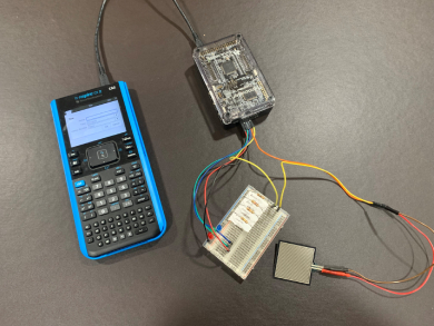 TI graphing calculator pluged into an Arduino Board and a BreadBoard