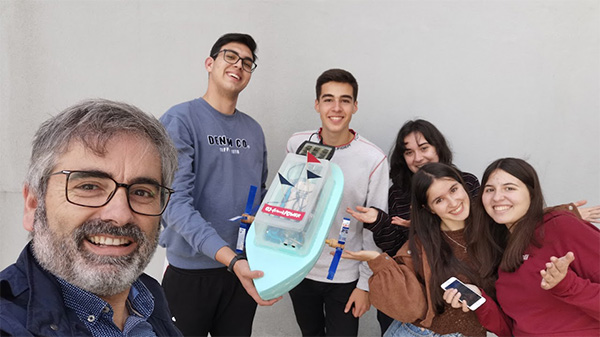 Science teacher Alexandre Gomes and his students with their robot-boat